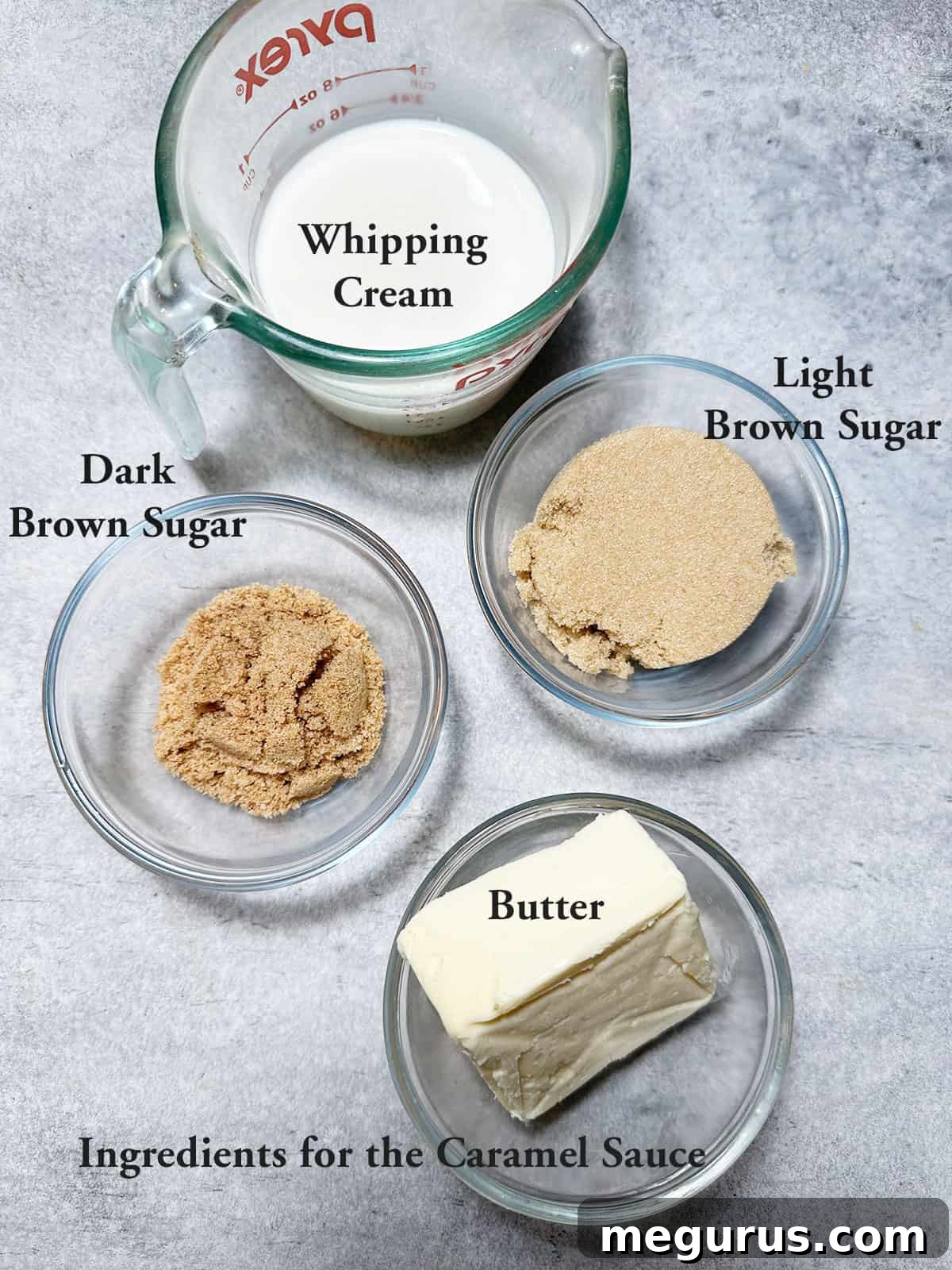 Key ingredients for making homemade caramel sauce: butter, brown sugar, and heavy whipping cream, arranged on a rustic wooden surface.