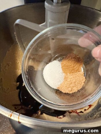 Adding dark molasses and a blend of warm spices, including nutmeg and cinnamon, to the creamed butter and sugar mixture.