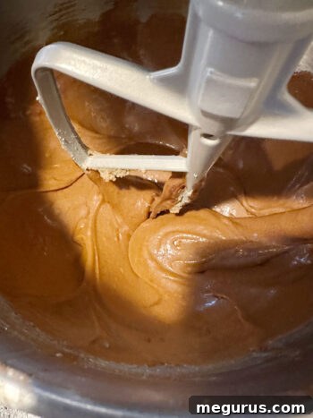 The well-combined gingerbread cake batter in the mixing bowl after the molasses and spices have been thoroughly incorporated.