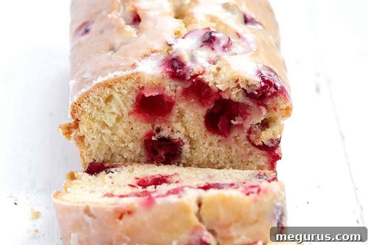 Cranberry orange loaf sliced, glazed and ready to eat
