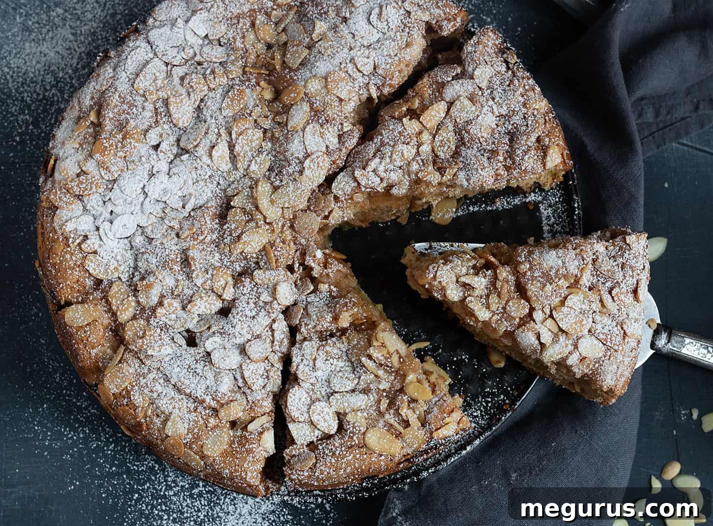 Slices of moist rhubarb sour cream cake topped with almonds and cinnamon sugar