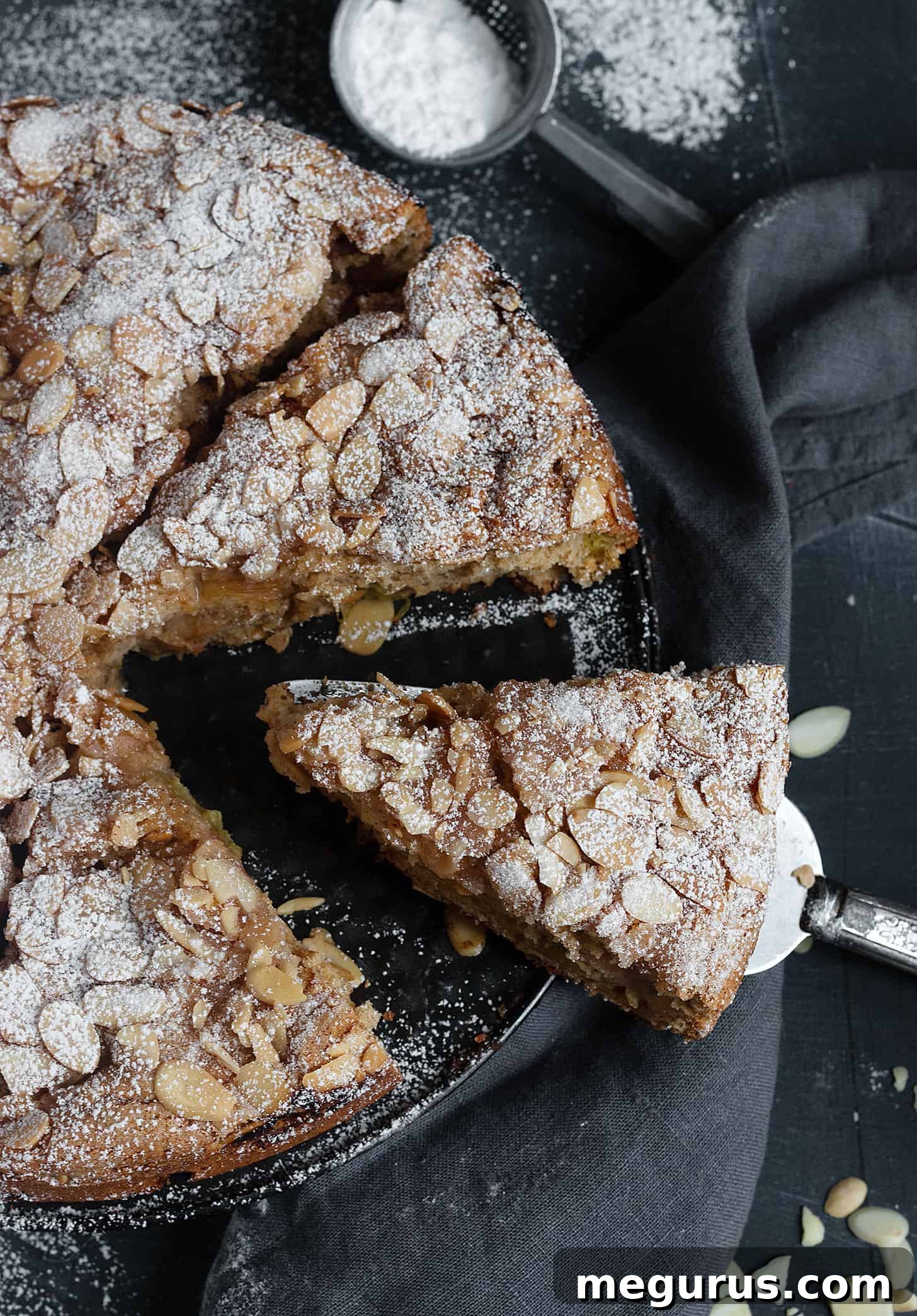 Close-up of a beautifully sliced rhubarb sour cream cake, showing moist interior and topping
