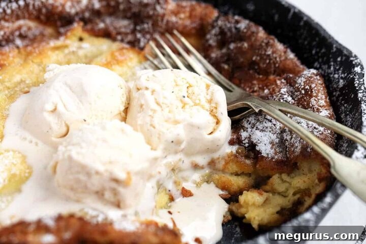 Bananas Foster Dutch Baby in a cast iron skillet with ice cream