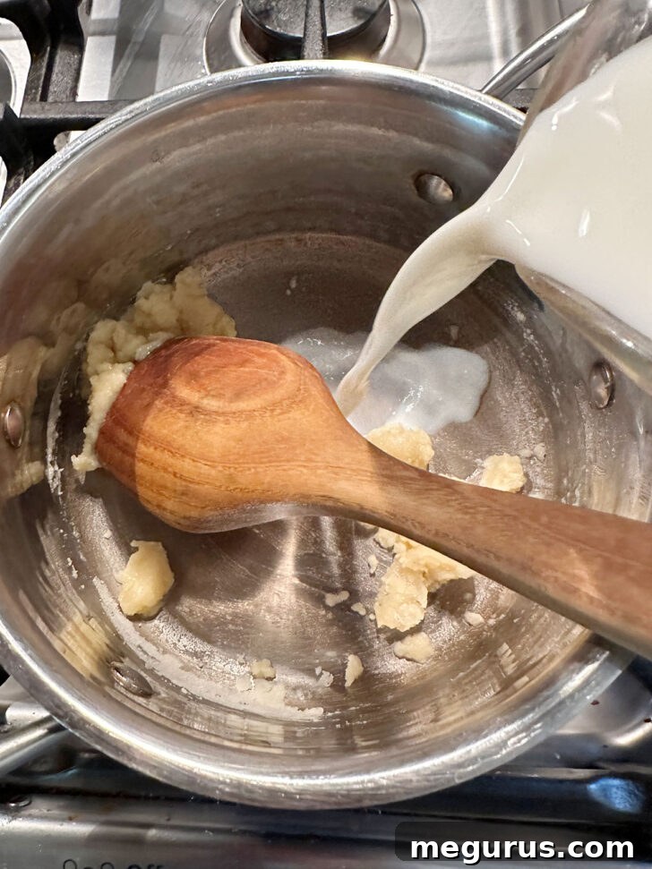 adding milk to pan