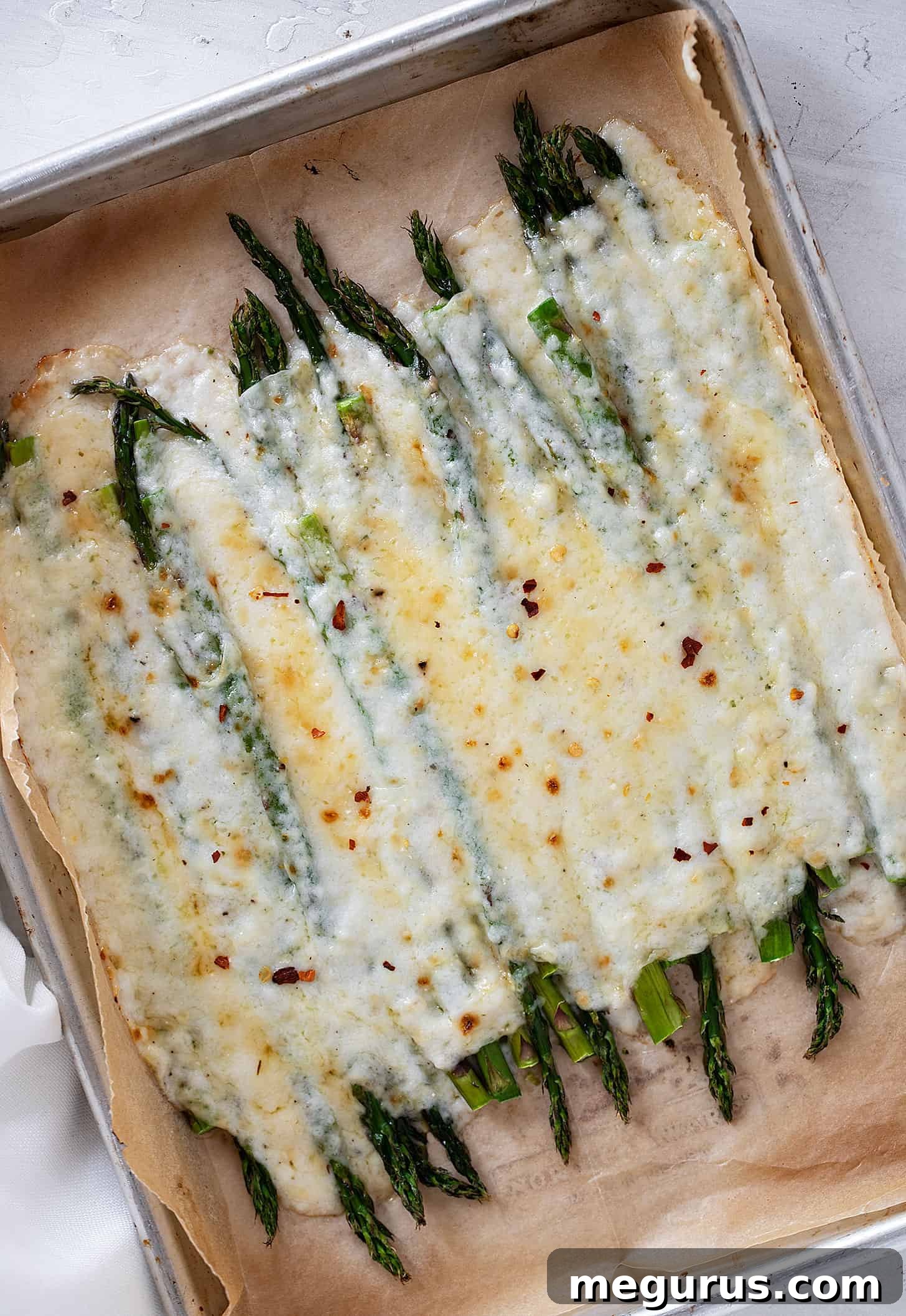 creamy asparagus on baking sheet