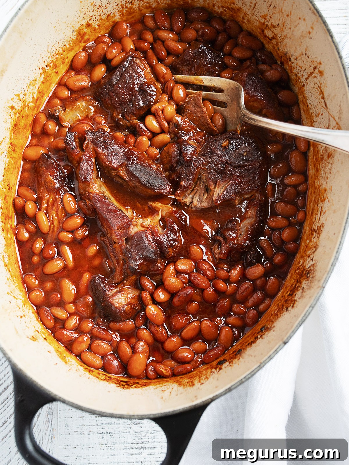 Pork and beans in a Dutch oven.