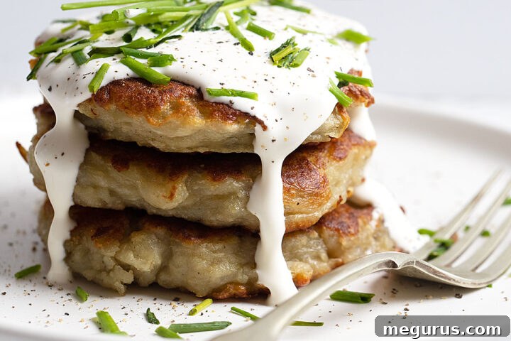 Irish Boxty stacked on plate with sour cream