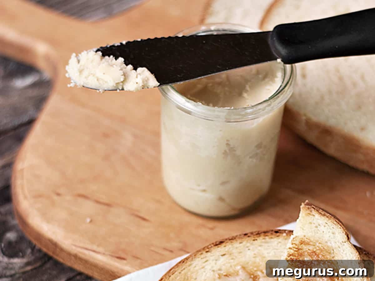 Creamy maple butter and fresh bread on a rustic cutting board, ready for spreading