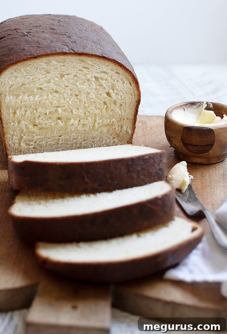Buttermilk yeast bread sliced on cutting board.