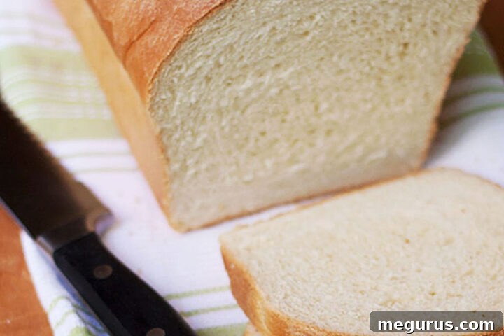 Freshly baked and sliced maple yeast bread, showing a soft, inviting crumb