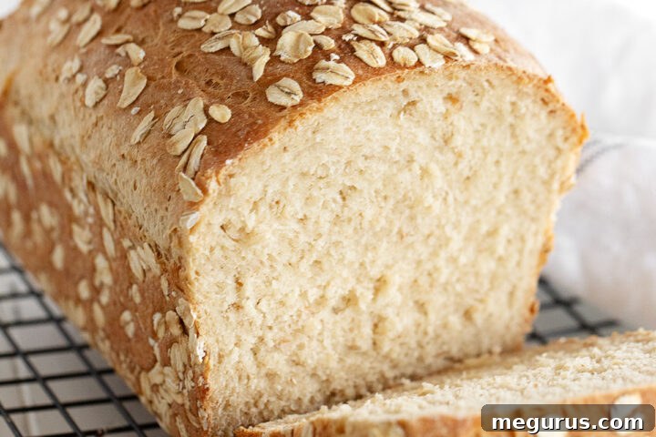 Honey oat bread sliced on cooling rack.