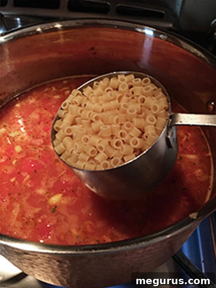 Adding the pasta to the pasta fagioli.
