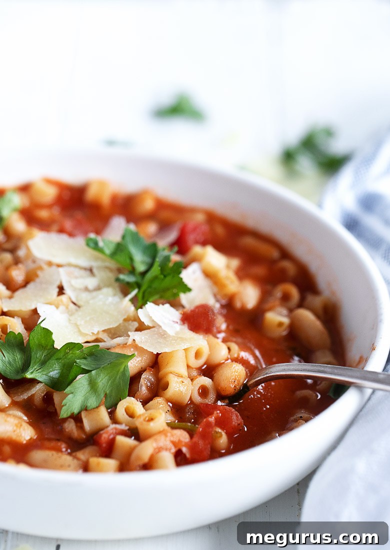 pasta e fagioli in white bowl with spoon