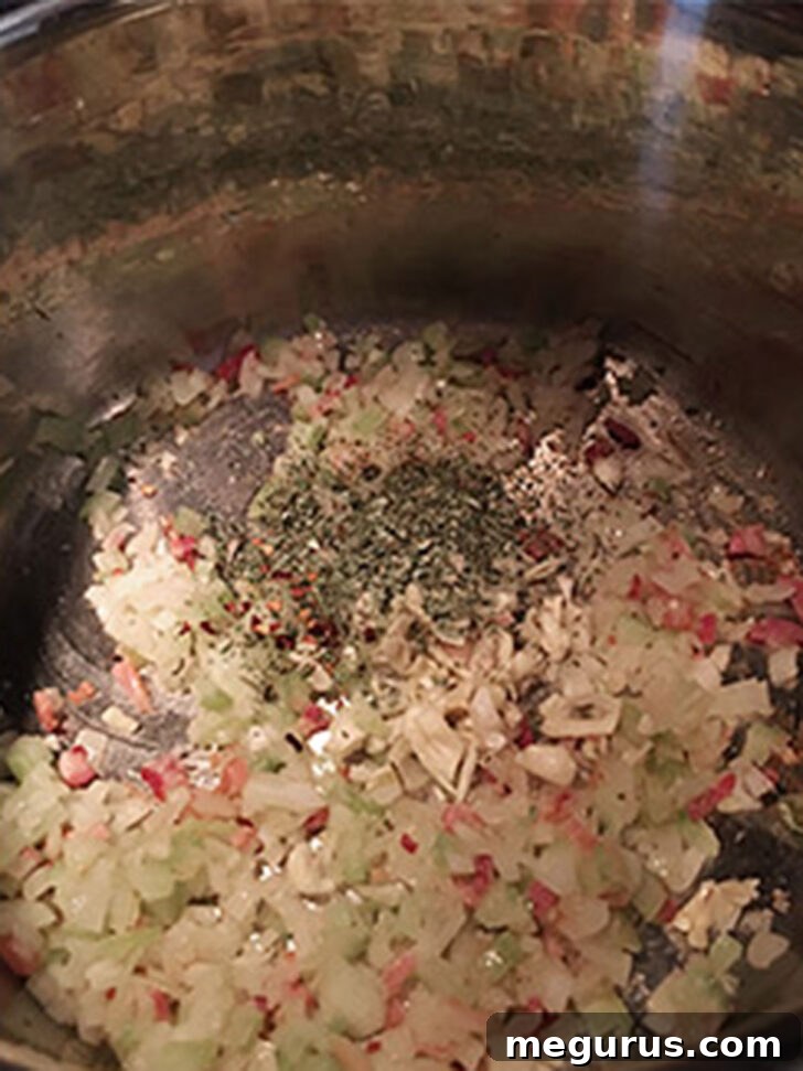 Garlic and herbs added to the pot.