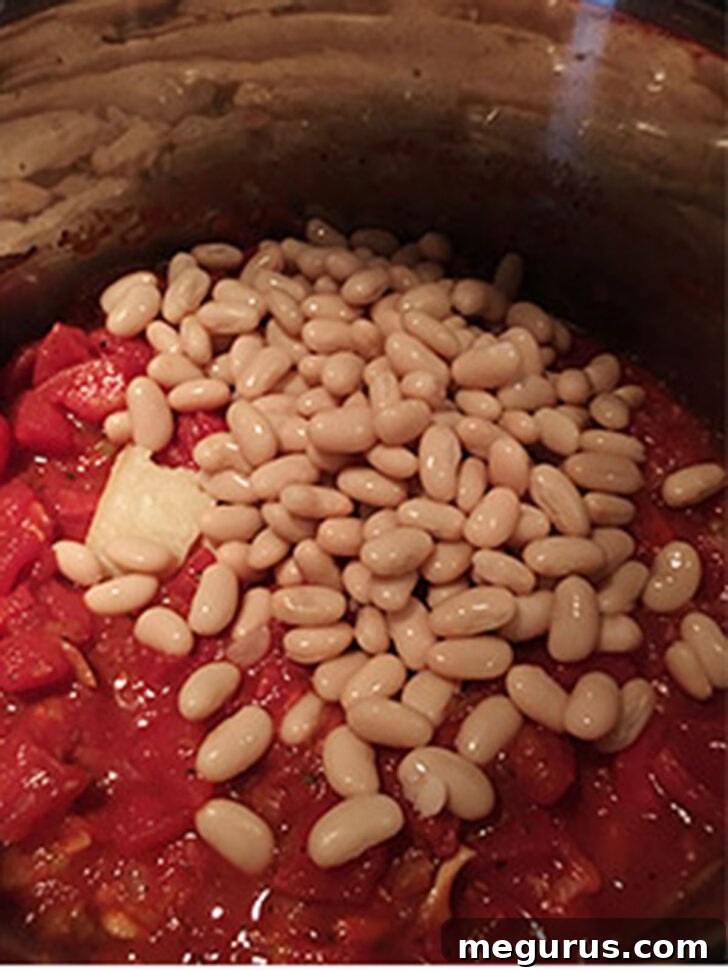 Adding the beans to the pot.