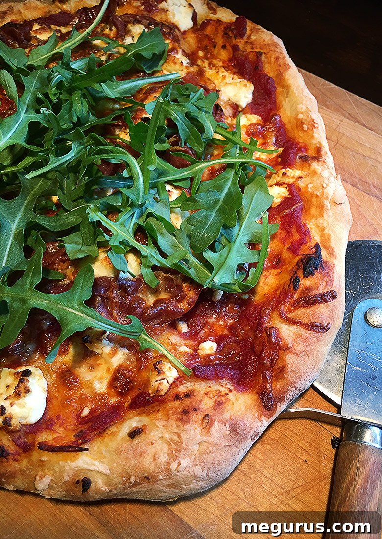 Freshly baked homemade pizza being sliced on a wooden cutting board, showcasing its golden crust and delicious toppings