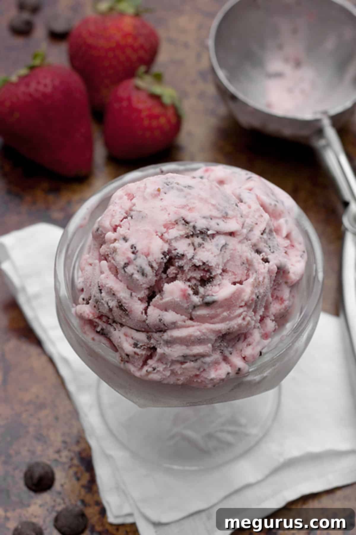 Closeup of chocolate strawberry ice cream in a bowl, showing the intricate chocolate swirl and creamy strawberry base.
