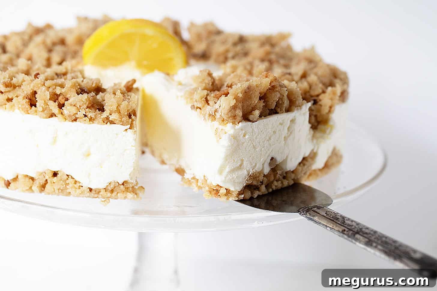 Exquisite frozen lemon dessert on a cake stand, elegantly sliced for serving.