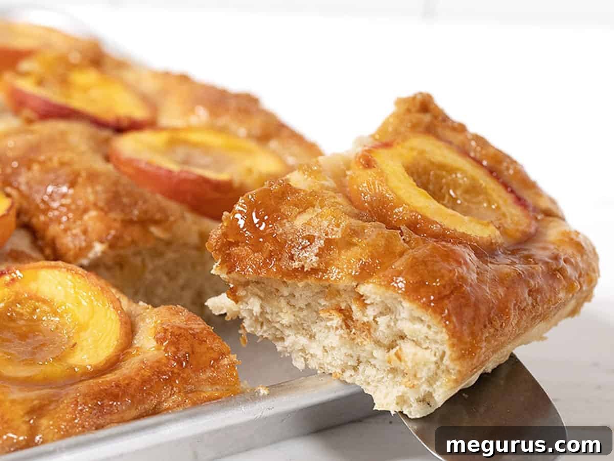 Baltimore peach cake in pan with slice