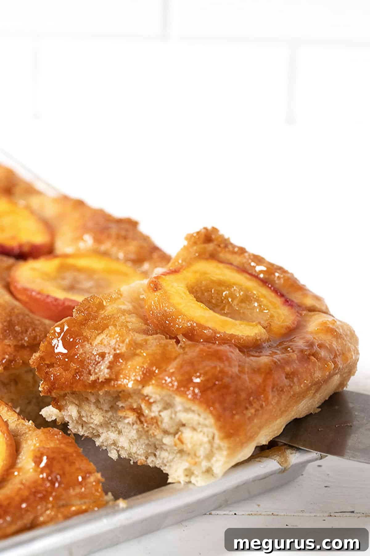 Baltimore peach cake in pan with slice