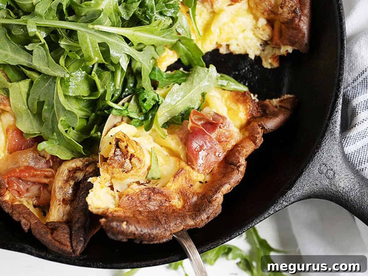 prosciutto Dutch baby in skillet with arugula