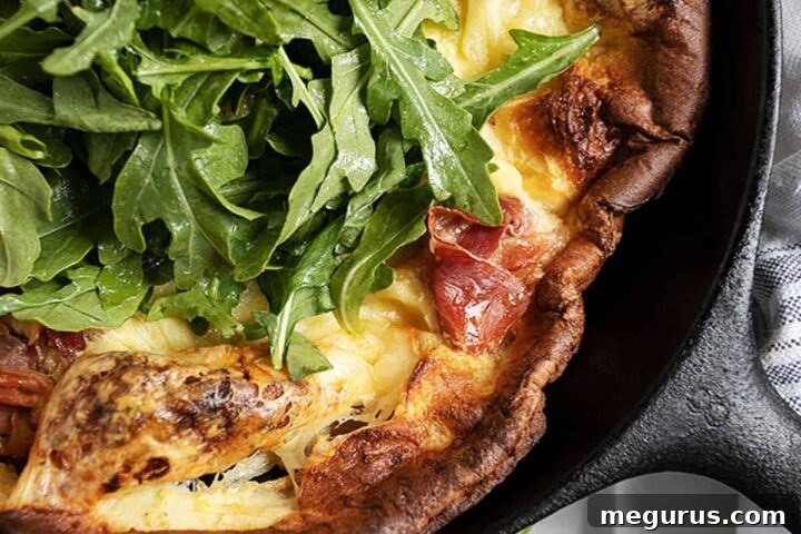 prosciutto Dutch baby in skillet with arugula