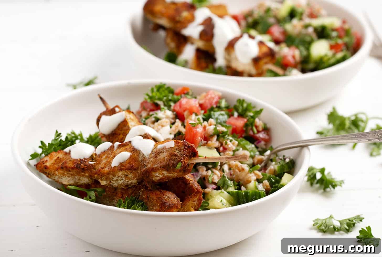 Chicken shawarma skewers served with a grain salad.
