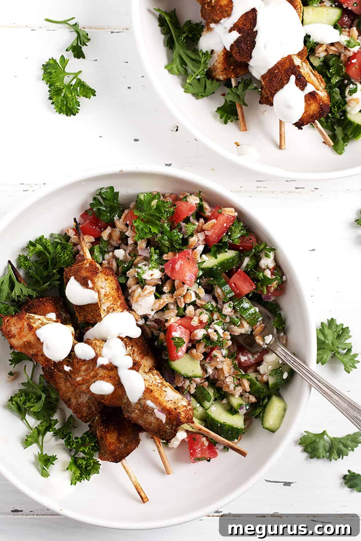 shawarma chicken on skewers on plate with tabbbouleh