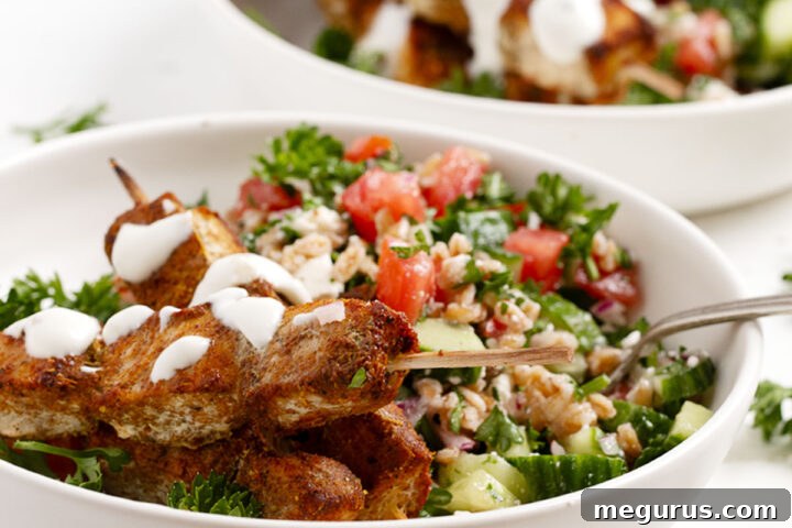 Chicken shawarma skewers served with a grain salad.