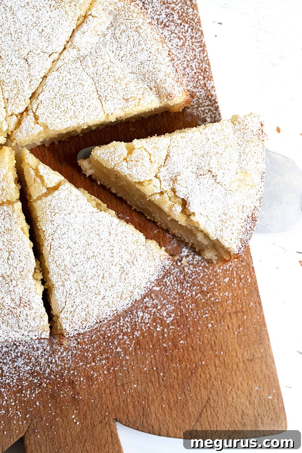 Italian apple cake sliced on cutting board