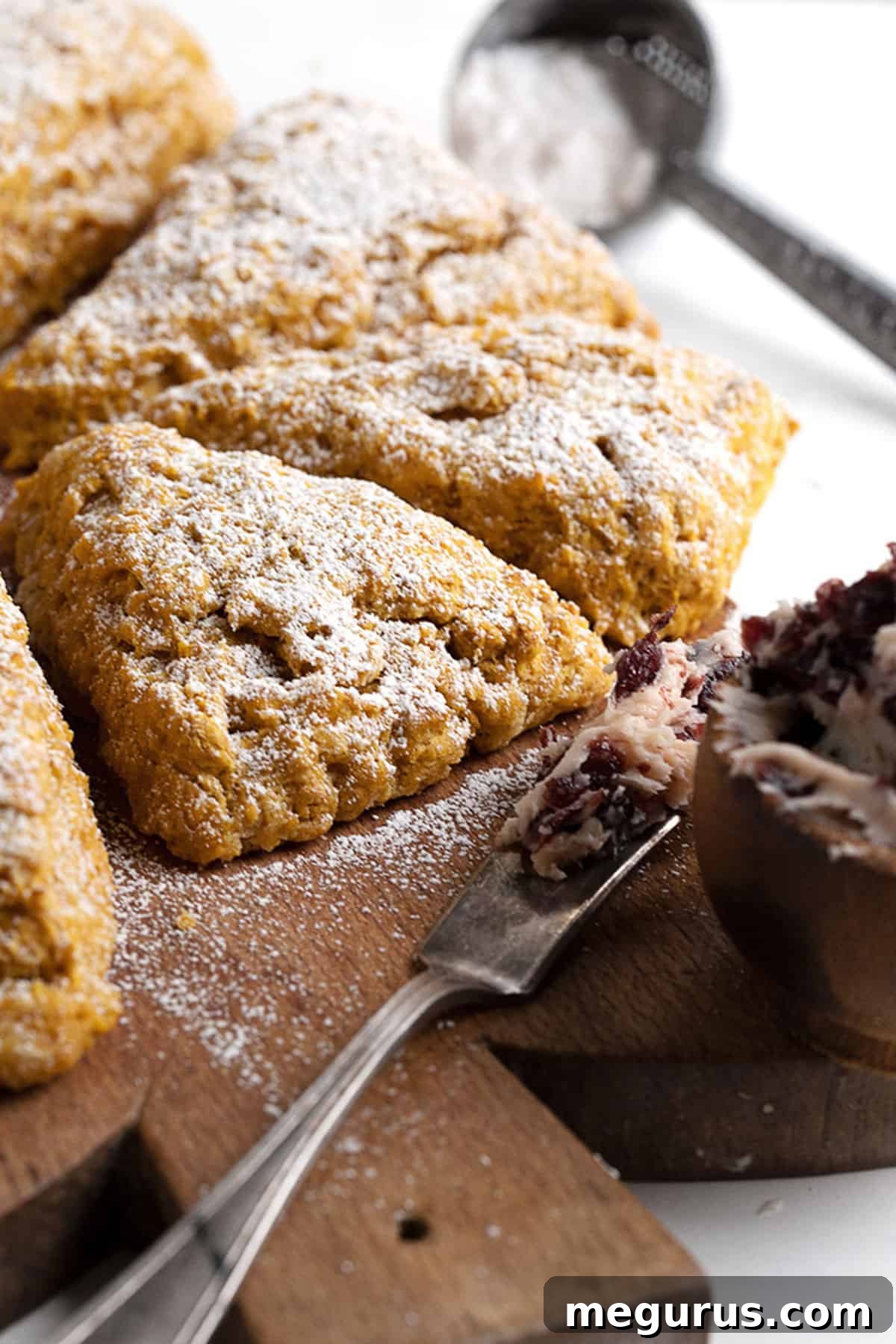 pumpkin scones on cutting board with cranberry butter