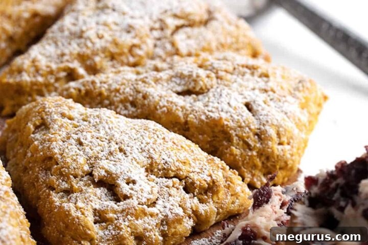 pumpkin scones on cutting board with cranberry butter