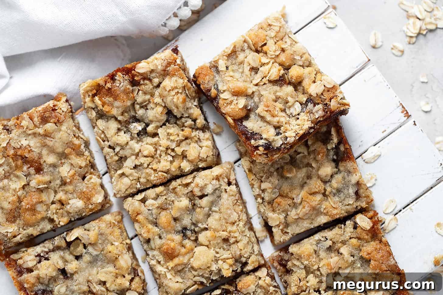 Old-fashioned date squares cut on serving board, showcasing the perfect balance of crumb and filling.