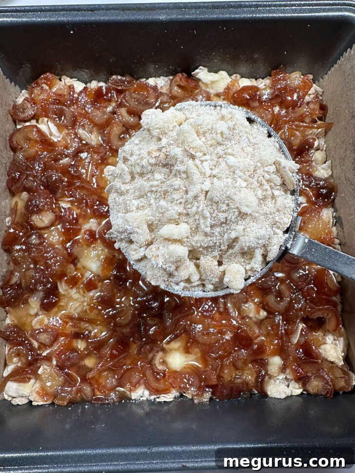 Baking pan with date filling spread over the base, ready for the topping.