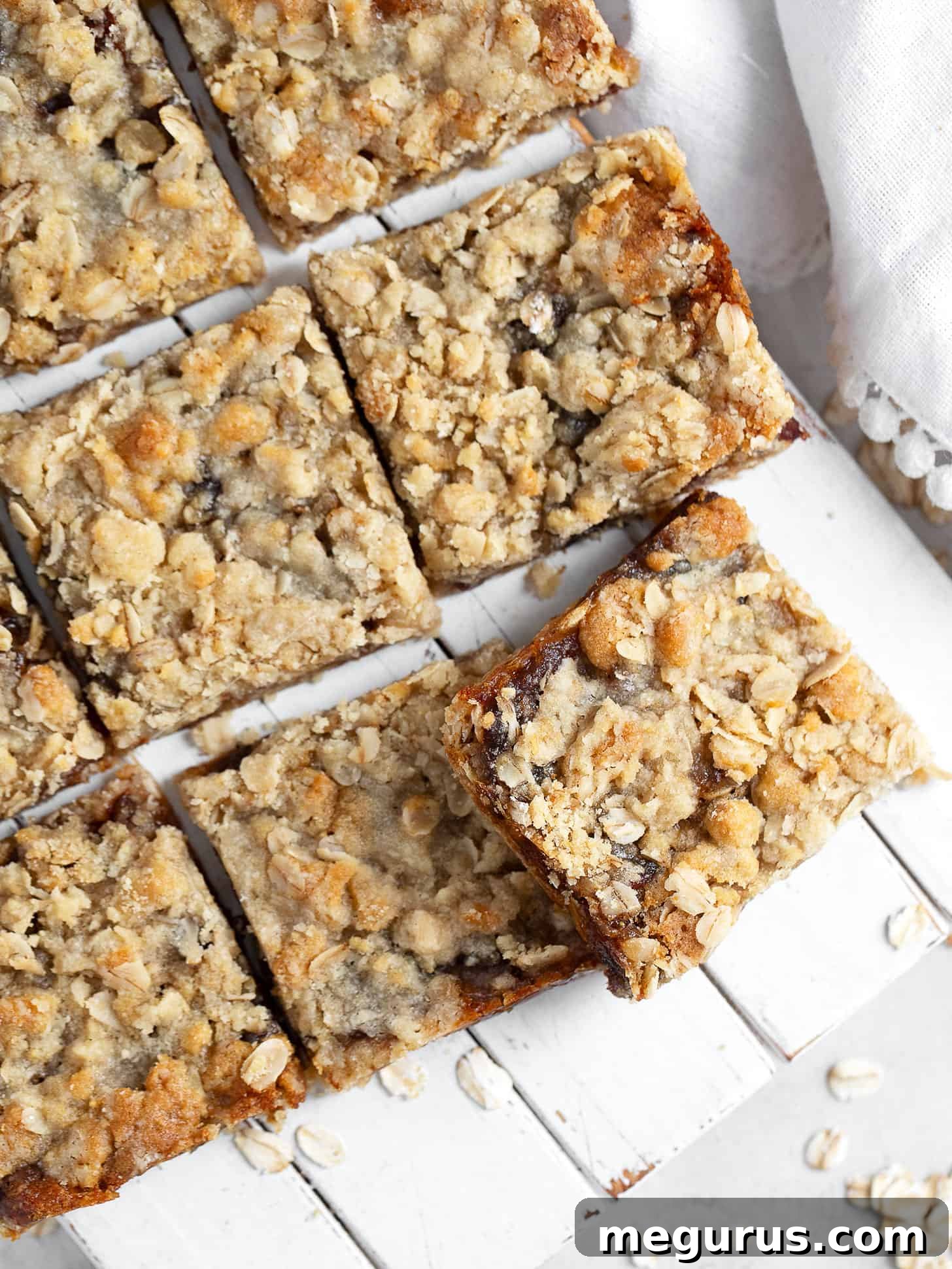 Old-fashioned date squares neatly cut and arranged on a serving board, ready to be enjoyed.