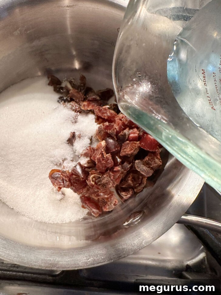 Adding chopped dates, white sugar, and water to a saucepan for the date filling.