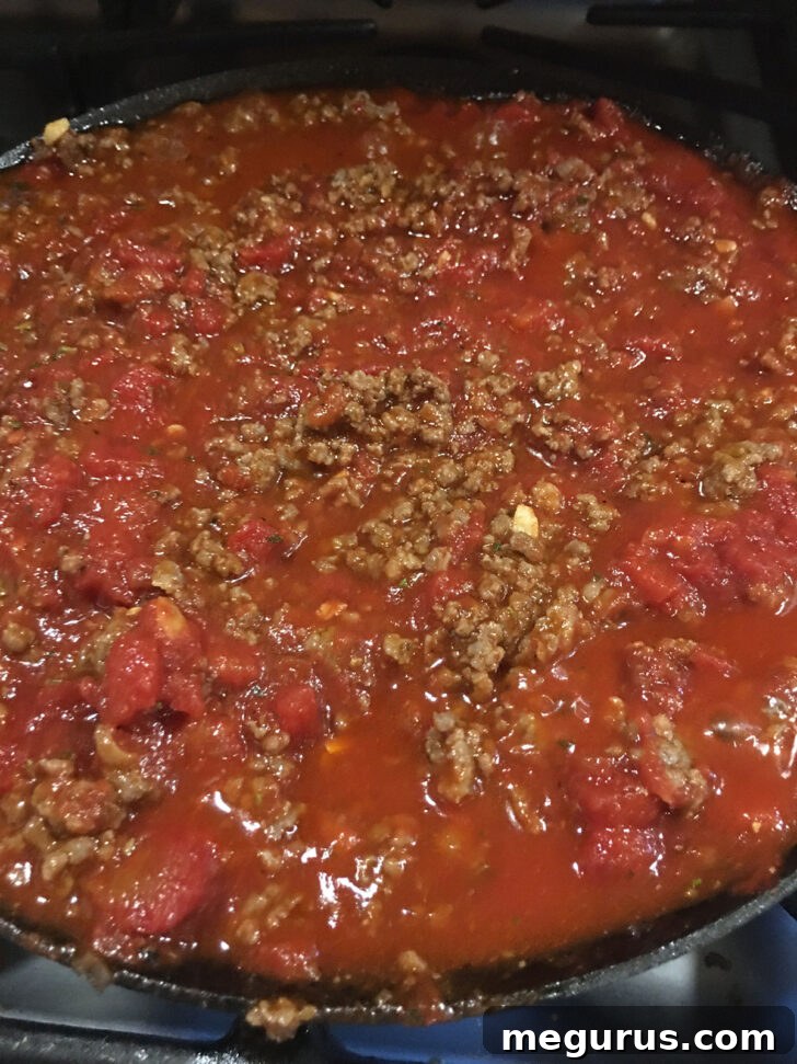 FInished meat sauce in skillet, rich and simmering.