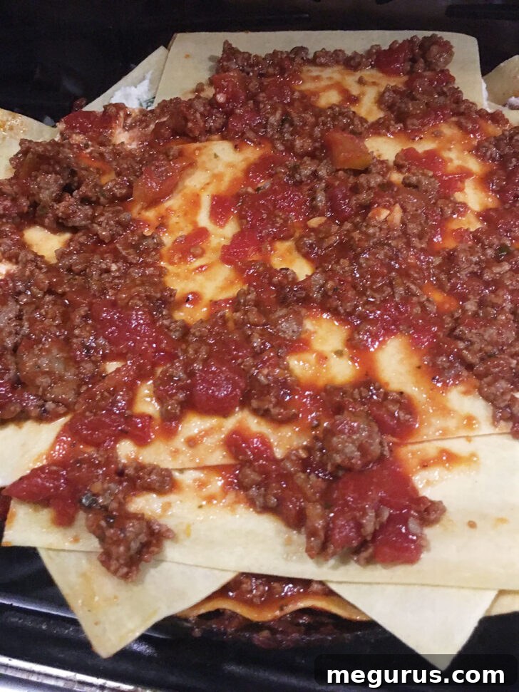 Fully assembled lasagna in the skillet, ready for the oven.