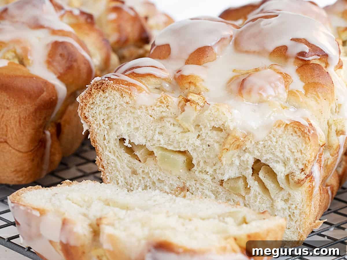 chunky apple bread sliced on cooling rack