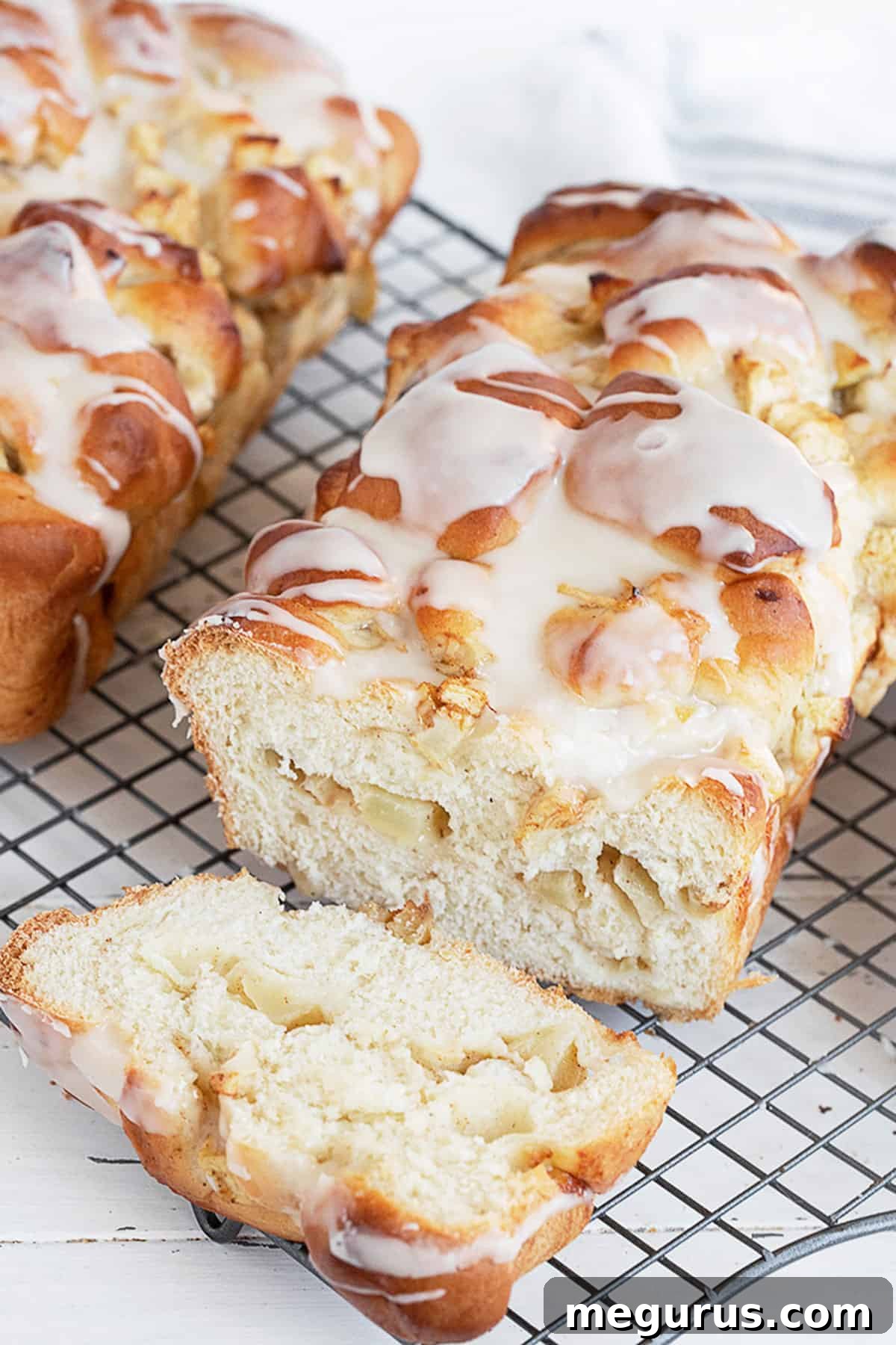 chunky apple bread sliced on cooling rack