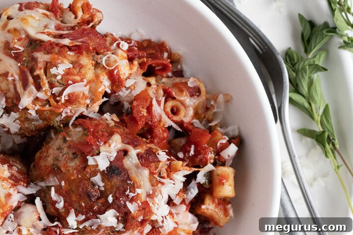Pork meatball pasta bake in a white bowl
