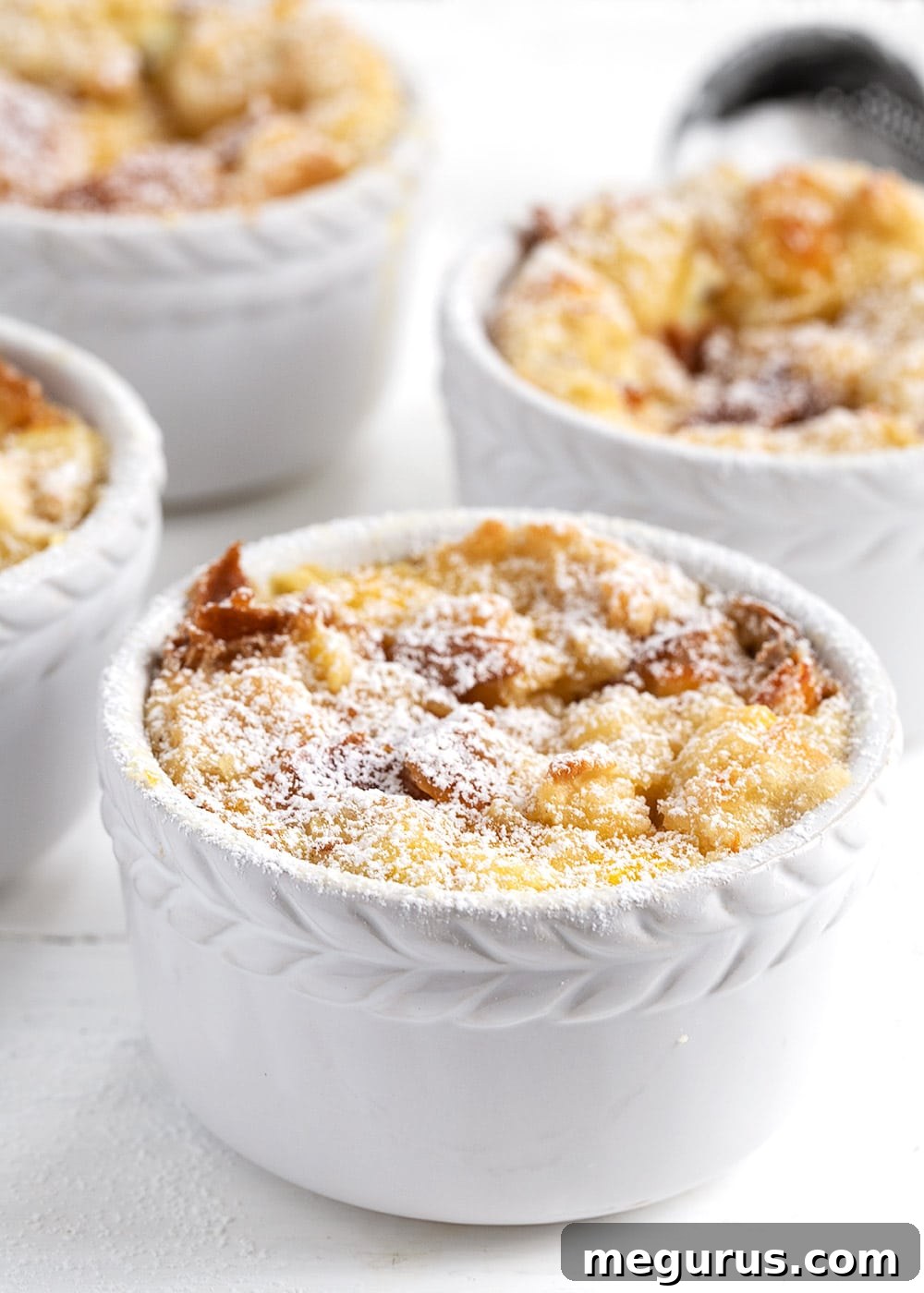 Individual orange marmalade bread and butter pudding in ramekins