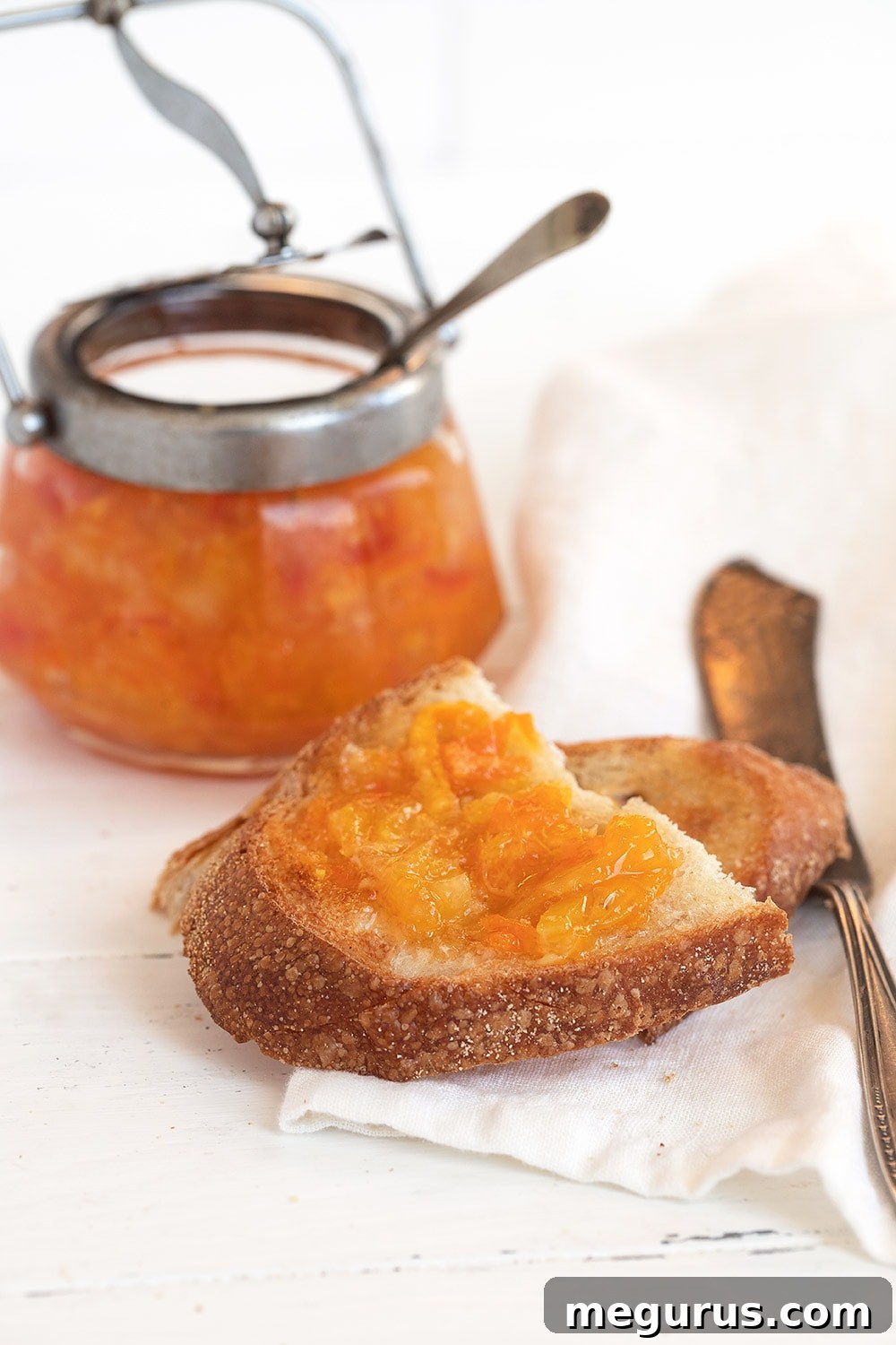 orange marmalade in jar and spread on toast