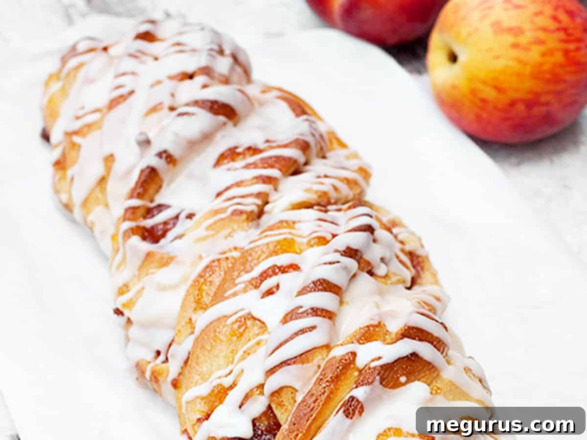 close-up of peach flip bread with a sweet glaze drizzle and almonds on a wooden board