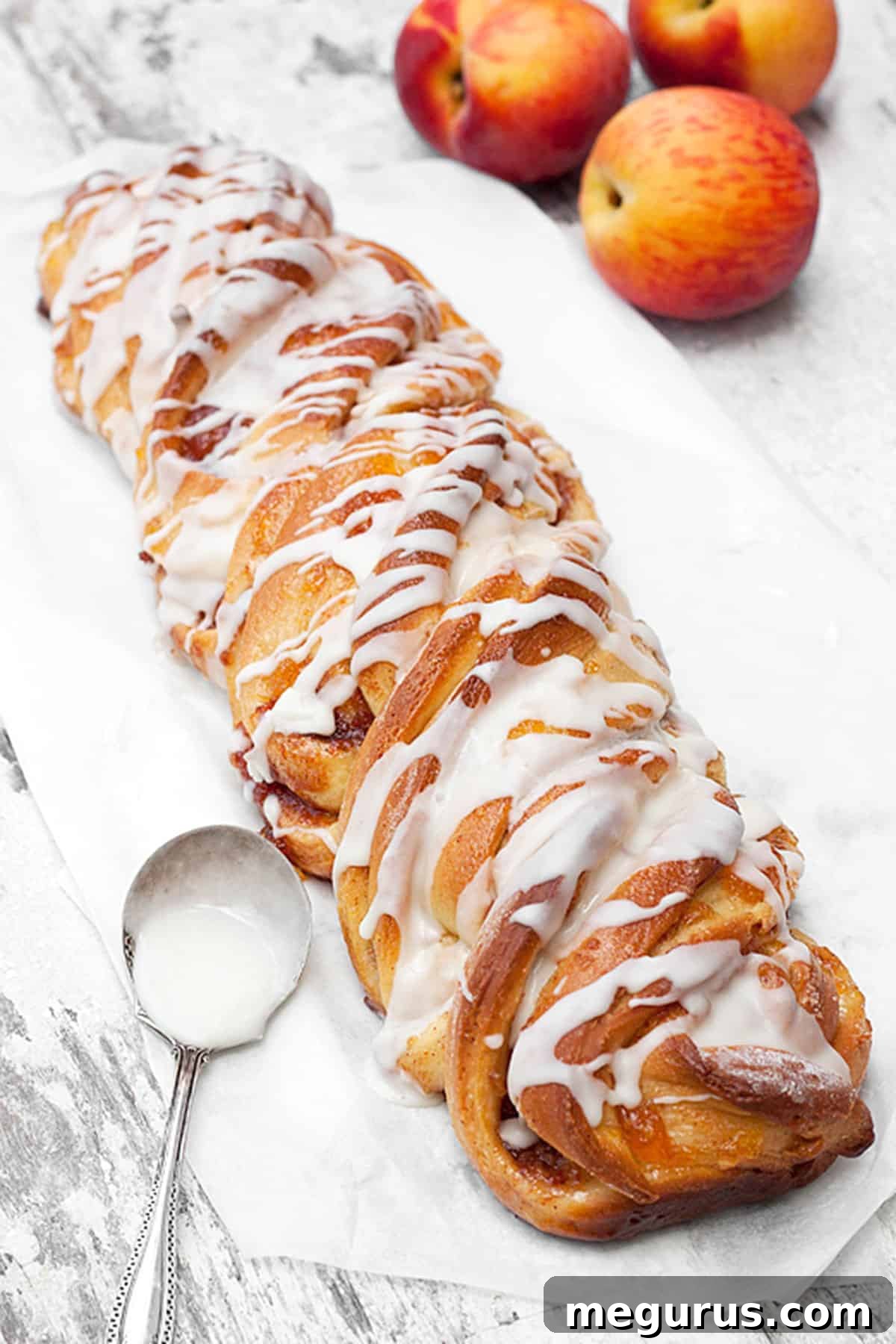 peach flip bread with a sweet vanilla glaze drizzle on a cooling rack