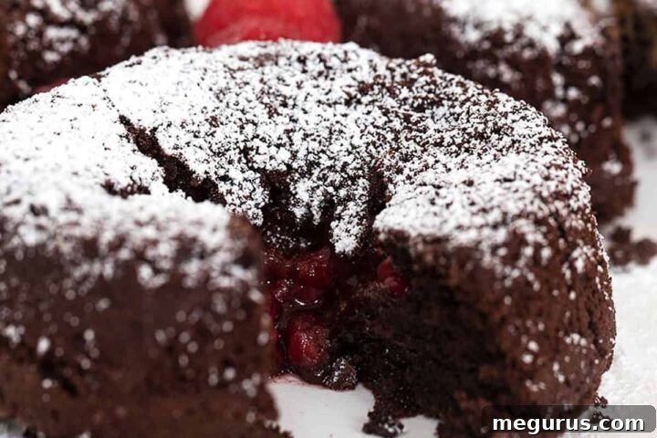 A close-up of a delectable chocolate molten cake with a vibrant raspberry filling, a perfect dessert.