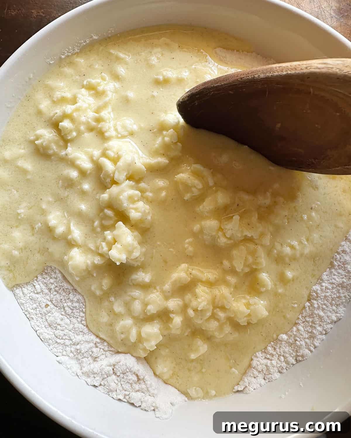 adding wet ingredients to dry ingredients