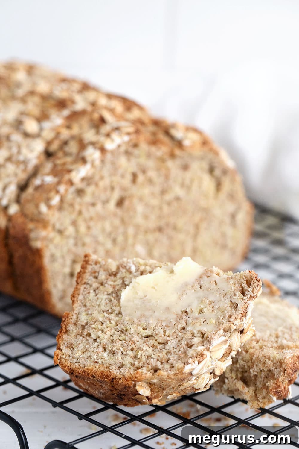 brown Irish soda bread sliced on cooling rack with butter, ready to enjoy
