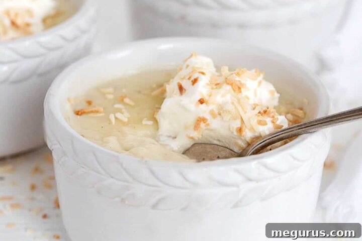 coconut cream pudding in ramekins with whipped cream on top