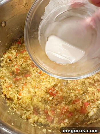 Adding cornstarch slurry to thicken the relish.